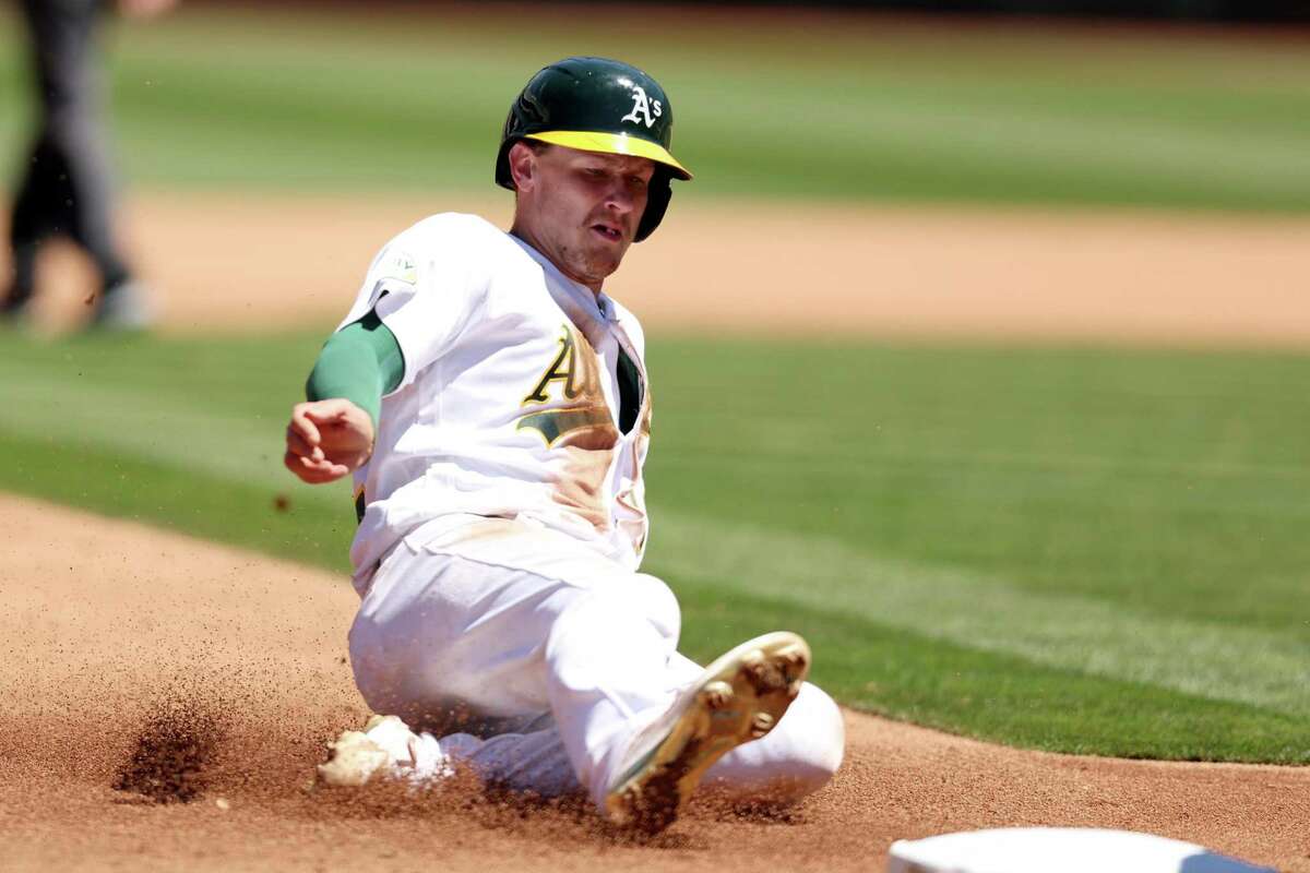 OAKLAND, CALIFORNIA - AUGUST 07: Sean Murphy #12 of the Oakland Athletics slides into third base in the fourth inning against the San Francisco Giants at RingCentral Coliseum on August 07, 2022 in Oakland, California. (Photo by Ezra Shaw/Getty Images)