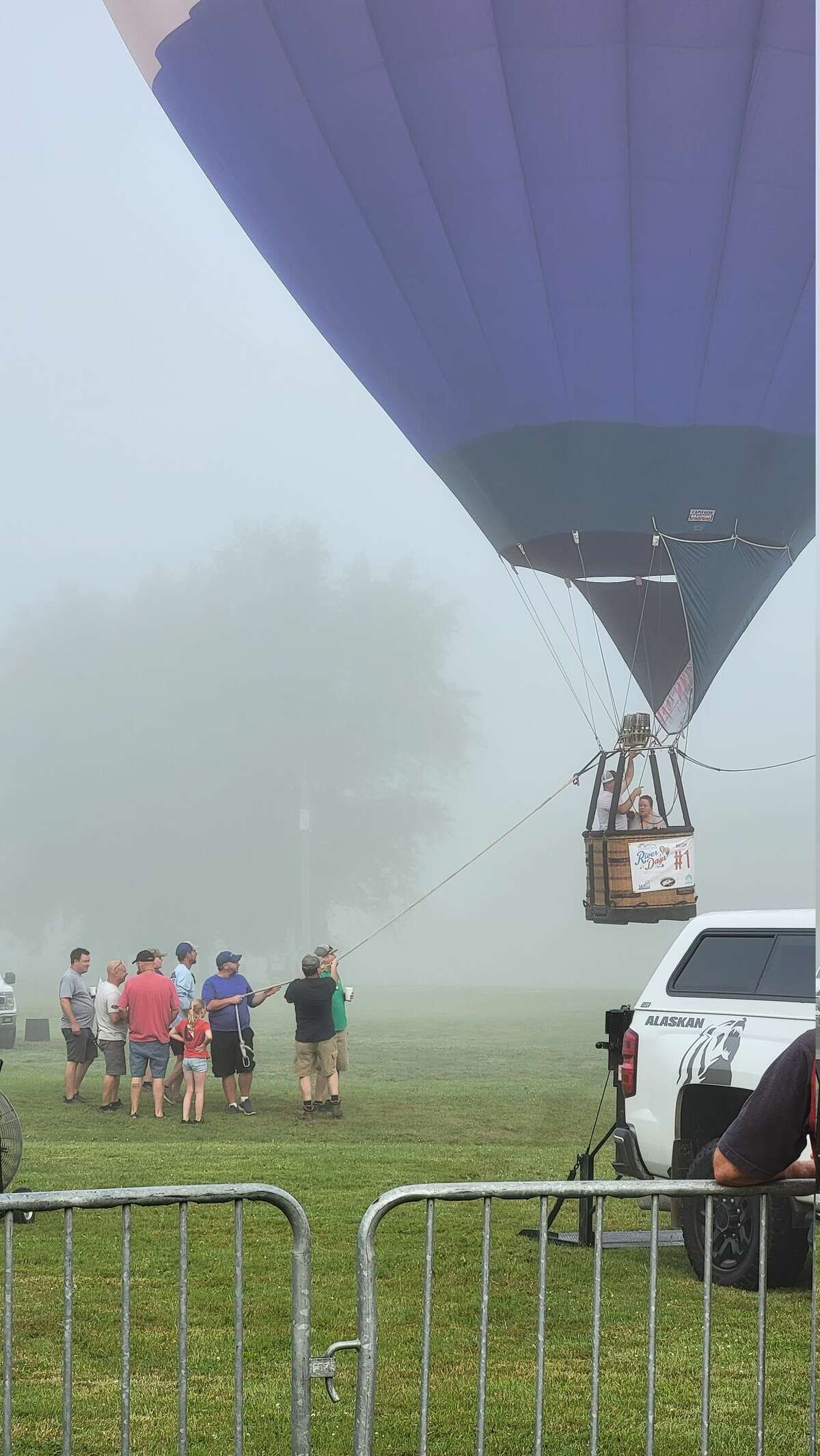 Tethered down by hot air balloon pilots, Tamala Marks and Dennis Hall hover above a misty Chippewassee park on Saturday, Aug. 6. "You could really feel the fog up in the air," Marks said. "It was really magical."