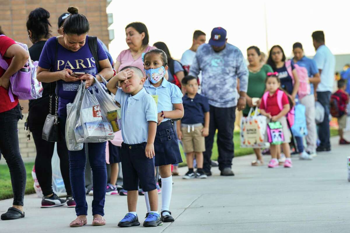 Parents line up with their children outside Alief ISD’s Martinez Early Learning Center for the first day of school Monday, Aug. 8, 2022 in Houston. Martinez is one of two new early learning centers in the district. There were 41,000 students returned to school in Alief ISD Monday.