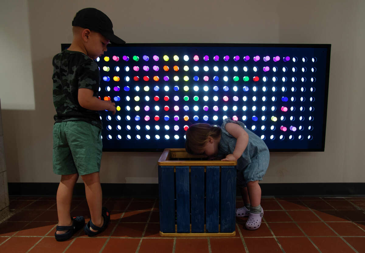 Noah Nelson, 4, left, of Mechanicville and Madison Barber, 16 months, of Glenmont, play with a giant light board at the new location of the Children's Museum at Saratoga in the Lincoln Bath House at Saratoga Spa State Park.