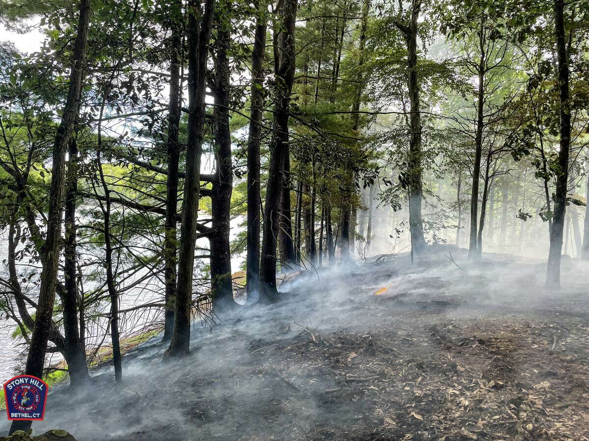 Crews from several area towns spent hours battling a brush fire near the Saugatuck Reservoir in Redding, Conn., Saturday, Aug. 6, 2022.