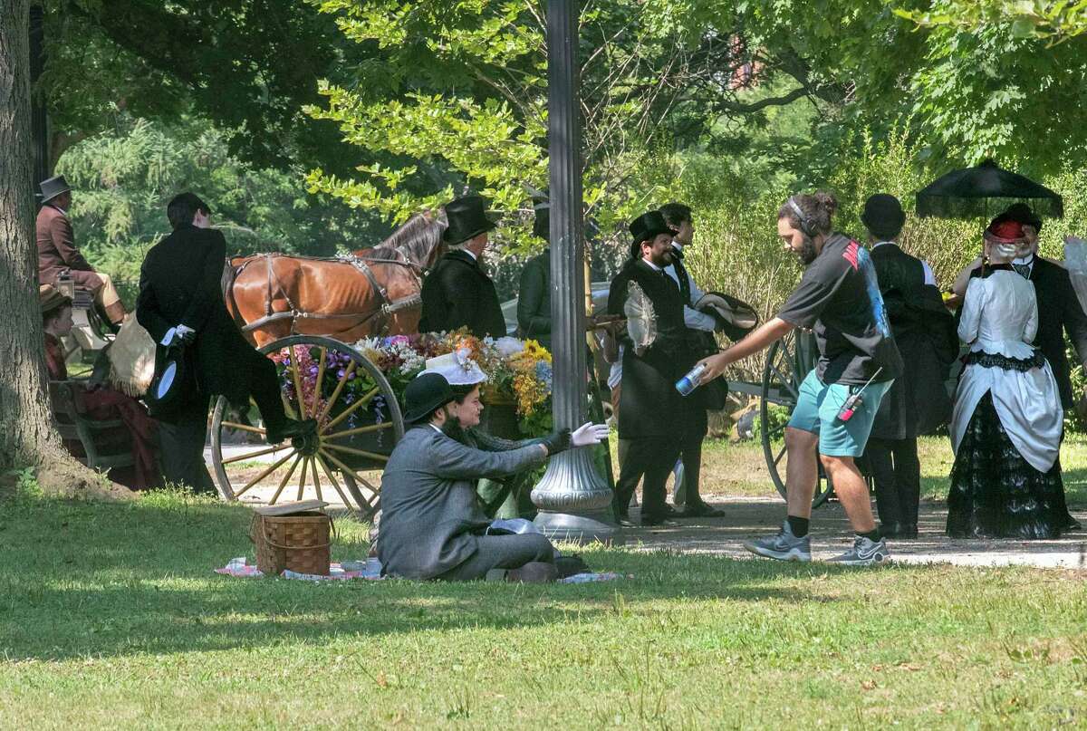 Crew members try to keep actors hydrated during the filming of the HBO series ‘The Gilded Age' in Washington Park on Monday, Aug. 8, 2022 in Albany, N.Y.
