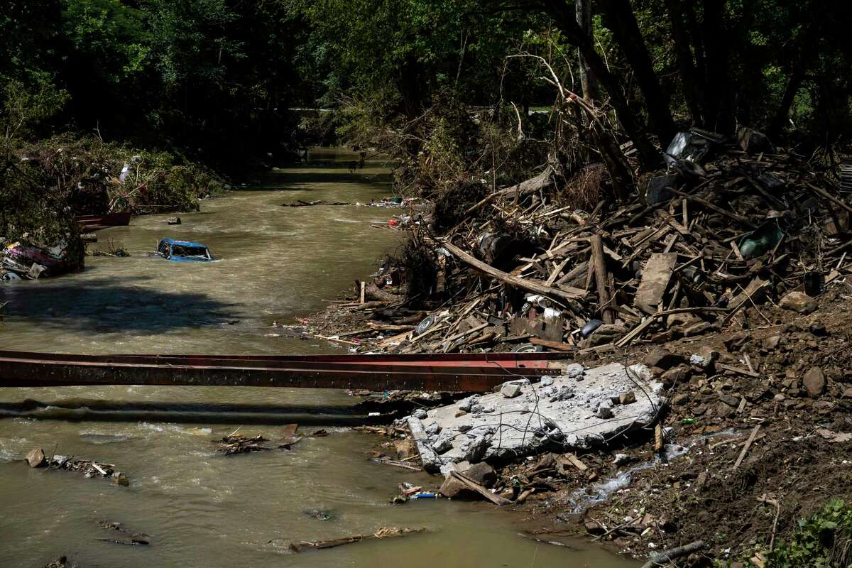 HAZARD, KY - AUGUST 06: A car is still partially submerged in Troublesome Creek in Perry County, Kentucky near Hazard on August 6, 2022. Thousands of Eastern Kentucky residents have lost their homes ater devastating rain storms have flooded the area over the past week. The death toll stands at 37 people. (Photo by Michael Swensen/Getty Images)