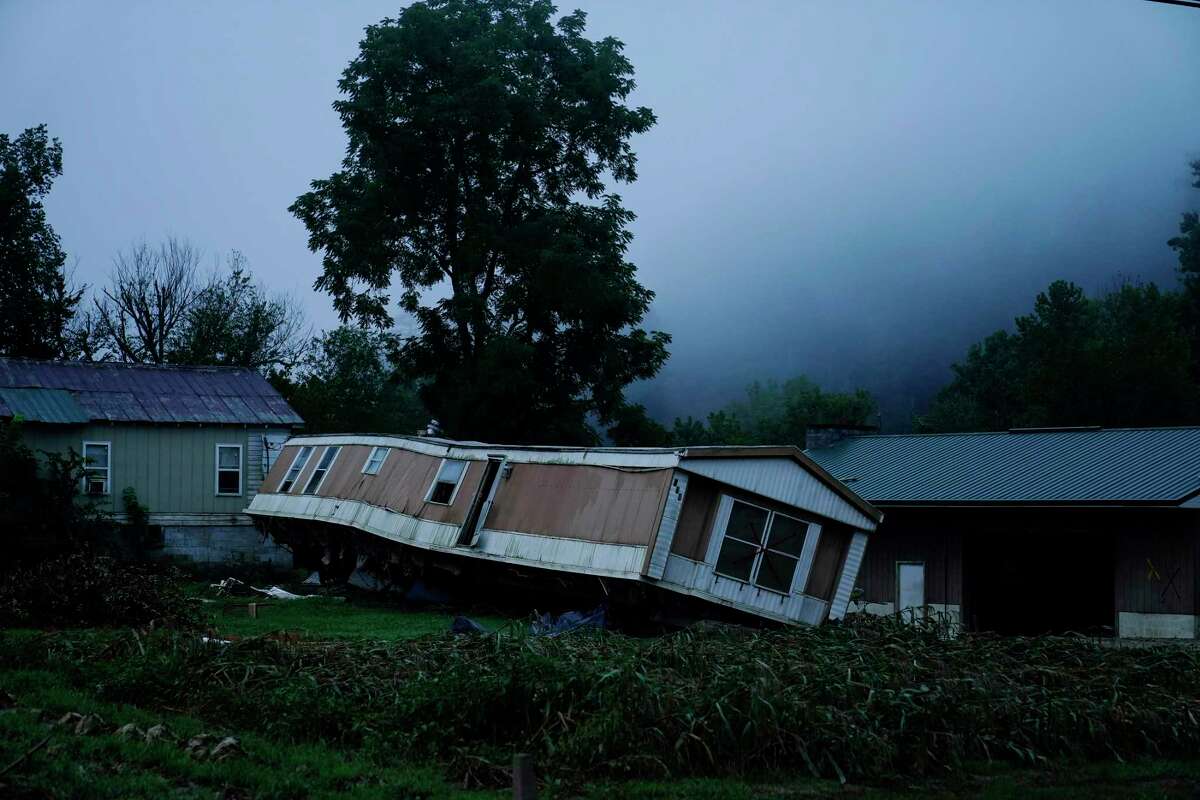 A trailer home was swept away by massive flooding on Friday, Aug. 5, 2022, near Lost Creek, Ky. As residents continued cleaning up from the late July floods that several people, rain started falling on already saturated ground in eastern Kentucky late Friday morning. (AP Photo/Brynn Anderson)
