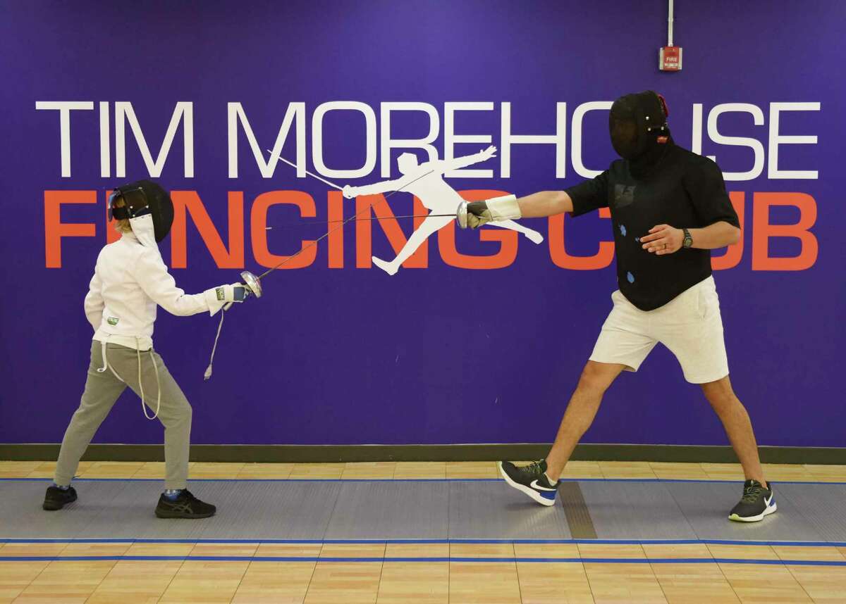 Fencing instructor Ahmed Abdallah, right, spars with his student, Xavier Kelly, at the Tim Morehouse Fencing Club at Chelsea Piers in Stamford on Thursday.