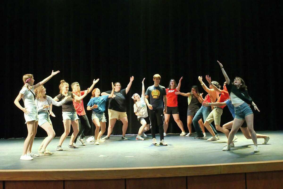Dickinson High School students demonstrate a warm-up drill as they prepare to serve as counselors at a recent theater camp.