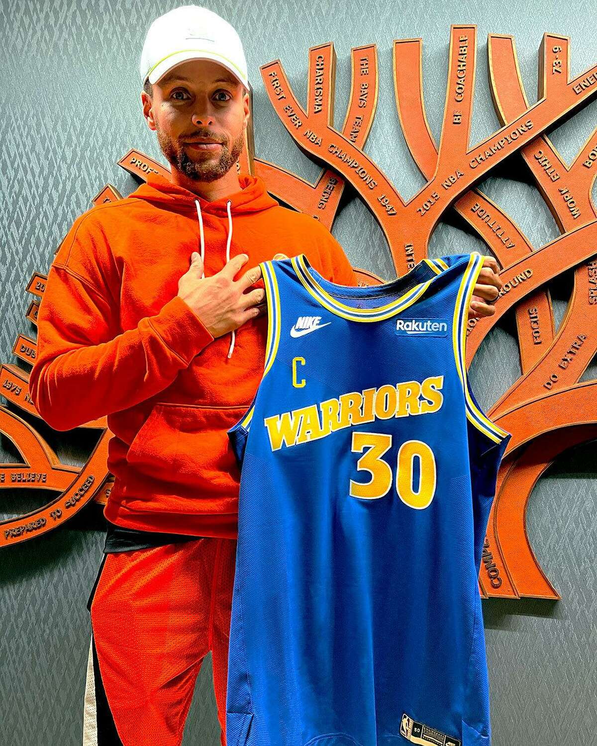Golden State Warriors star Stephen Curry shows off the team’s new alternate threads for next season, based on their uniforms from 1988-1997.