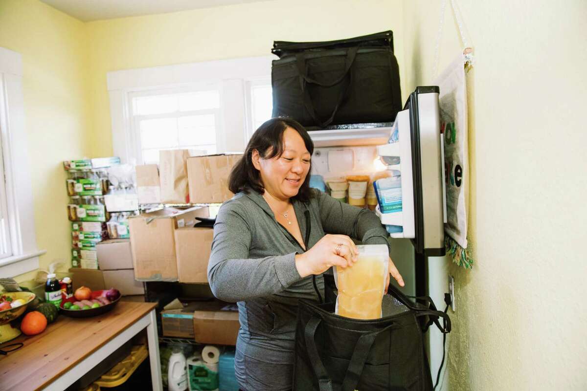 Nancy Chang, owner of the Purpose & Hope home restaurant, prepares soup to take to the Charlotte Maxwell Clinic.