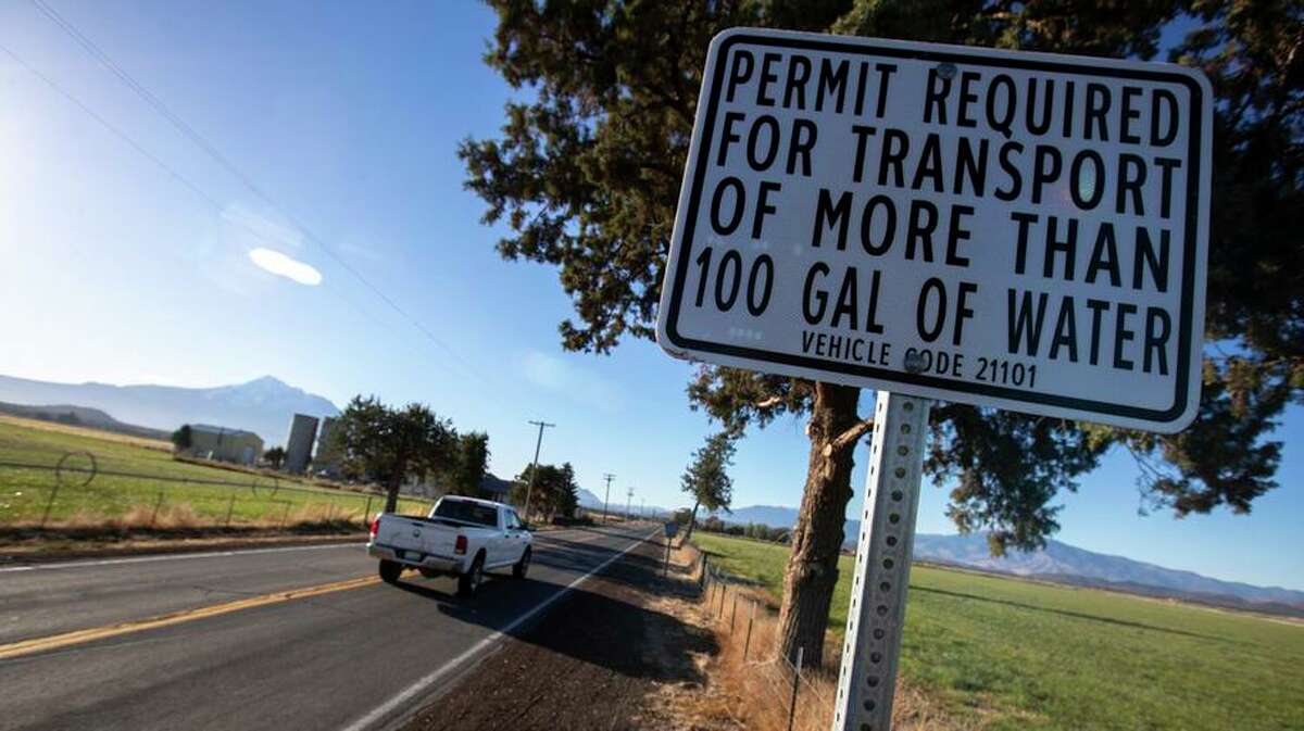 A road sign near an entrance to the Mount Shasta Vista subdivision warns of an ordinance requiring permits to haul more than 100 gallons of water on roads leading to the subdivision on Oct. 14, 2021, in Mount Shasta Vista, California.