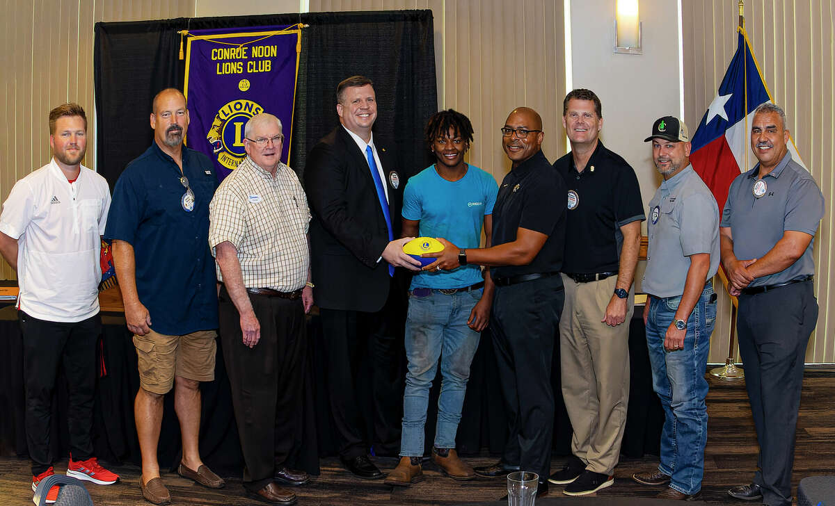 Tigers invade Lions Meeting: Last Wednesday during the annual Buddy Moorhead Pigskin Preview at the Conroe Noon Lions Club meeting, ex-CHS Tiger football players welcomed current CHS head coach Cedric Hardeman, 4th from right. Pictured (l-r) Kendall Hineman, James Boyd, Donnie Buckalew, club president Warner Phelps, Shamar Glover, Cedric Hardeman, Bobby Brennan, Jason Miller, and Ralph Perez. 
