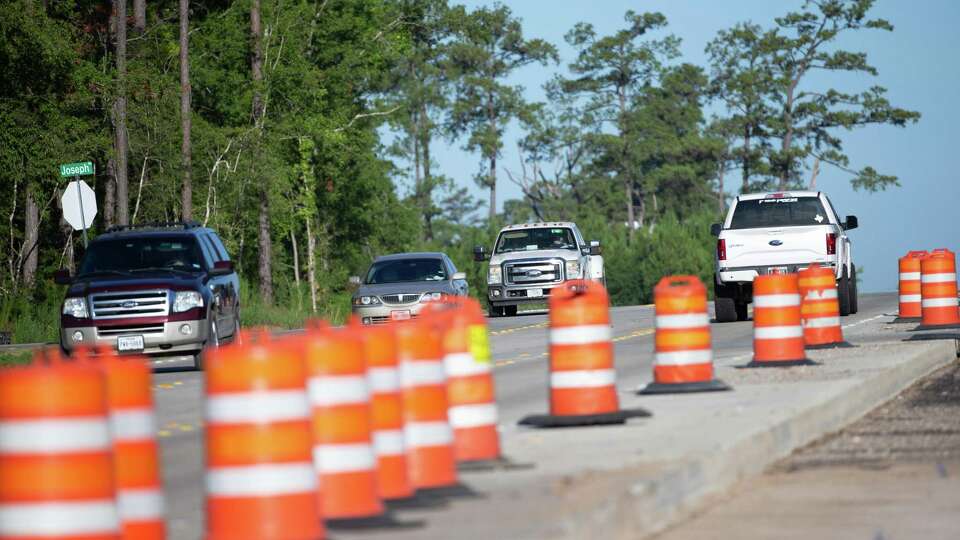 Morning traffic passes where crews are widening FM 1488 at Joseph Road on Monday, Aug. 8, 2022, in Magnolia. A $202 million project would widen the last 20-mile segment of FM 1488 that is one lane in each direction from Montgomery County to Hempstead and convert it to a four-lane divided highway through Waller County.