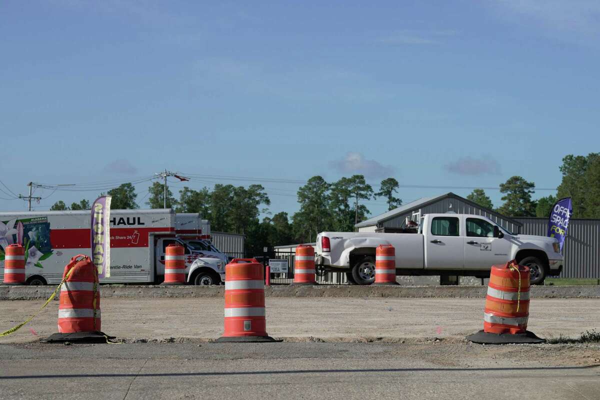 Morning traffic passes where crews are widening FM 1488 at Authors Drive on Aug. 8, 2022, in Magnolia. Recent road projects are costing more, making upcoming ones such as the next phase of FM 1488 into Waller County, potentially more expensive. 
