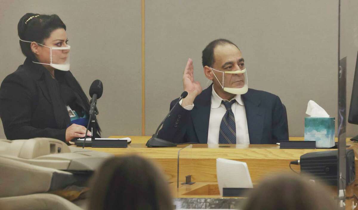 Yaser Said, 65, right, accused of killing his two teen daughters on New Year's Day 2008, takes the stand to testify Monday, August 8, 2022, during his capital murder trial at the Frank Crowley Courts Building in Dallas. (Liesbeth Power/The Dallas Morning News via AP)