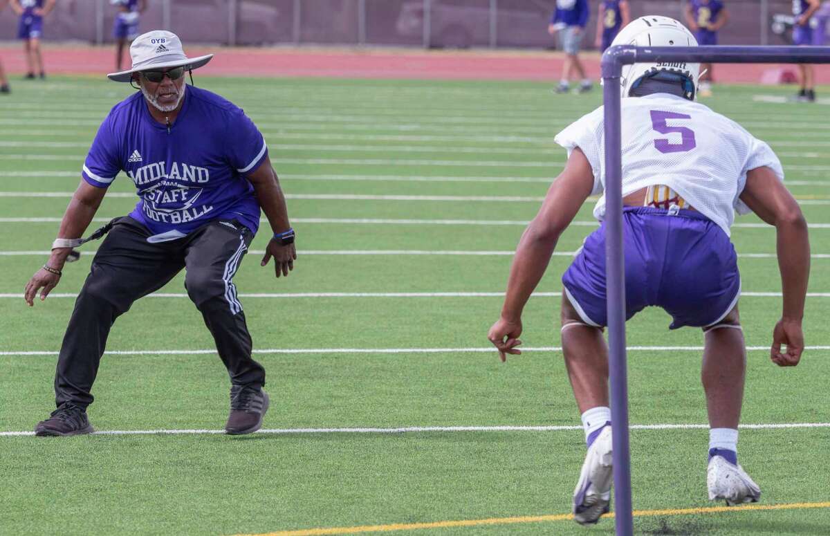 Midland High assistant coach Kirk Thurman works with players as they run drills 08/08/2022 during the first day of practice. Tim Fischer/Reporter-Telegram