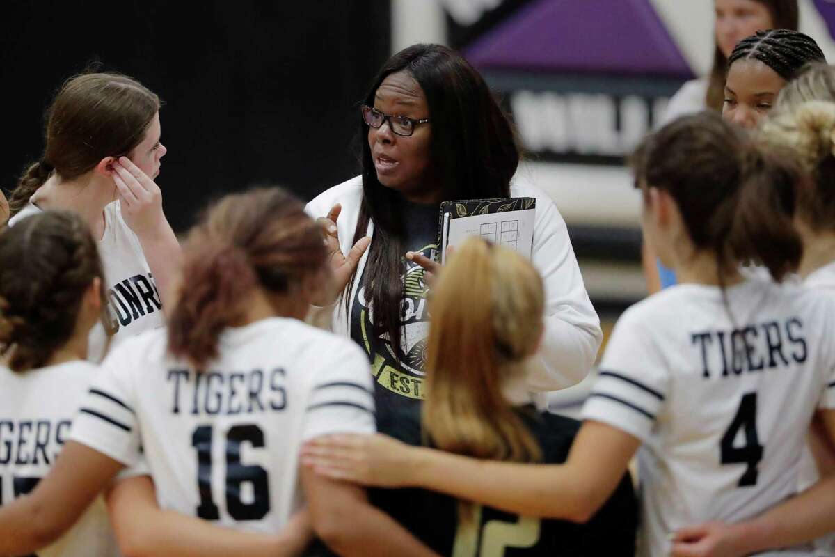 Conroe head coach Charvette Brown talks with her players during a time out in their high school volleyball match against Lufkin Monday, Aug. 8, 2022 played at Willis High School in Willis, TX.