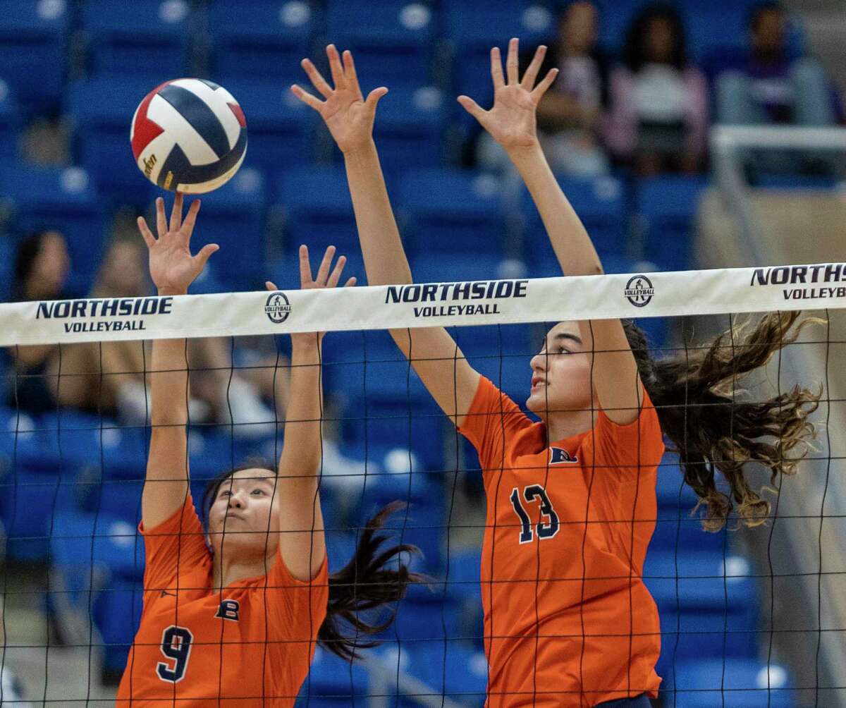 Brandeis’s Grace Xu, left, and Sophia Kuyn go for a block during the Broncos’ game against the O’Connor Panthers at the Northside Sports Gym.