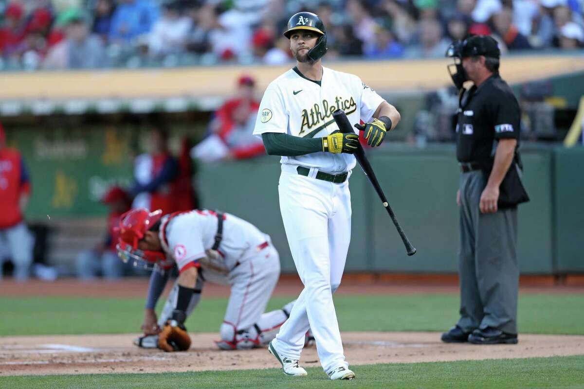 Oakland Athletics’ Chad Pinder walks back to dugout after striking out in 1st inning against Los Angeles Angels in MLB game at Oakland Coliseum in Oakland, Calif., on Monday, August 8, 2022.