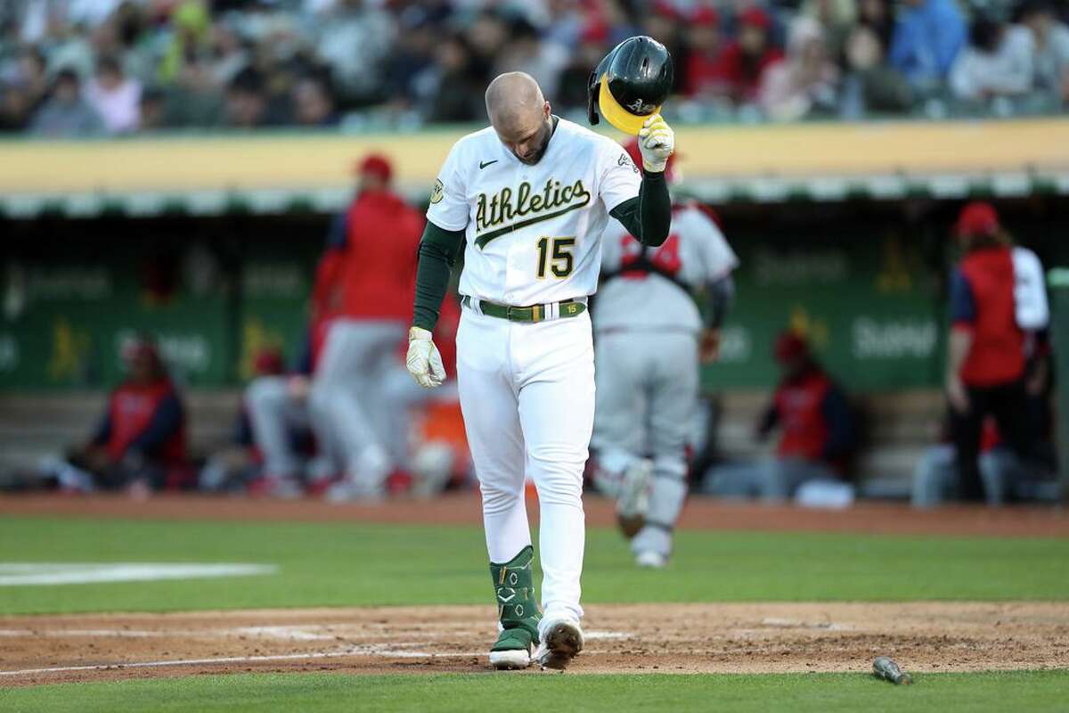 The Athletics’ Seth Brown throws his helmet after striking out against the Angels on Monday in Oakland.