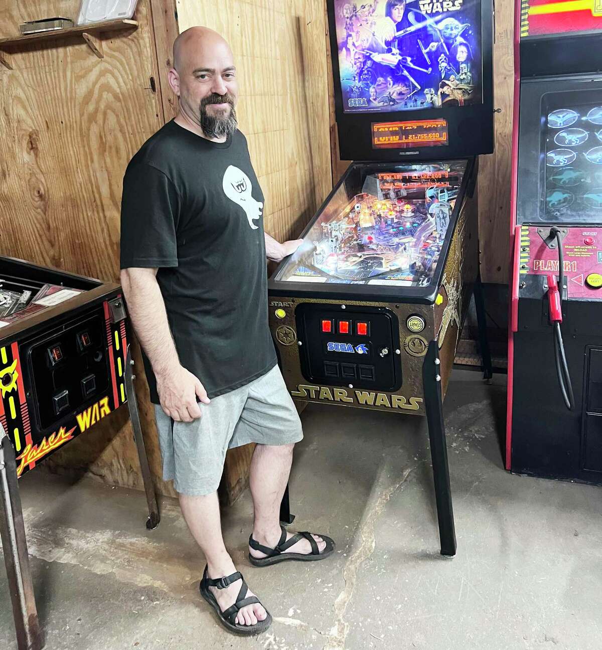 Brian Joy, shown in front of a 1996 Star Wars pinball machine, has a host of arcade games at the Pinshack, which he is opening at 12 Summit St. in East Hampton in September.
