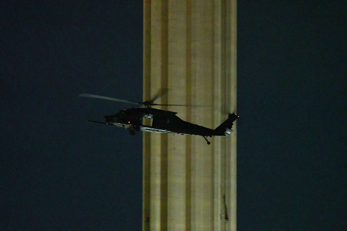 A UH-60 Black Hawk helicopter flies past the Tower of The Americas to land in the blacked out Alamodome parking lot as part of a training exercise conducted by the U.S Army's Special Operations Command on Monday.