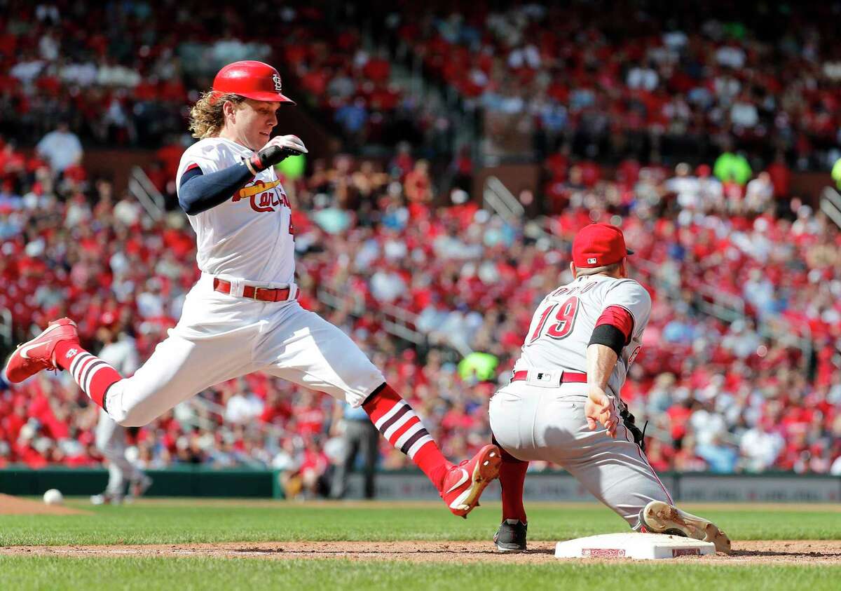 St. Louis Cardinals' Harrison Bader, left, grounds out as Cincinnati Reds first baseman Joey Votto handles the throw to end the sixth inning of a baseball game Sunday, Sept. 2, 2018, in St. Louis. (AP Photo/Jeff Roberson)