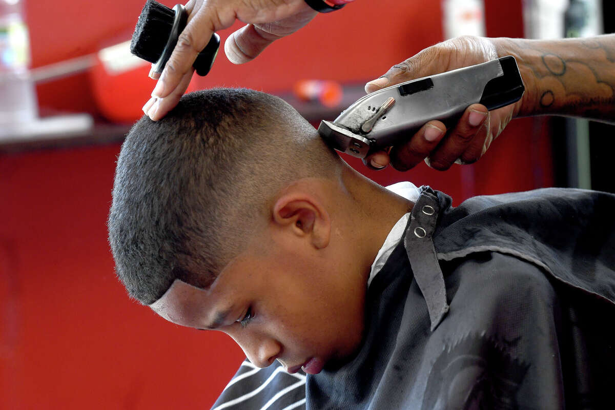 Photos Port Arthur barber offers free school haircuts