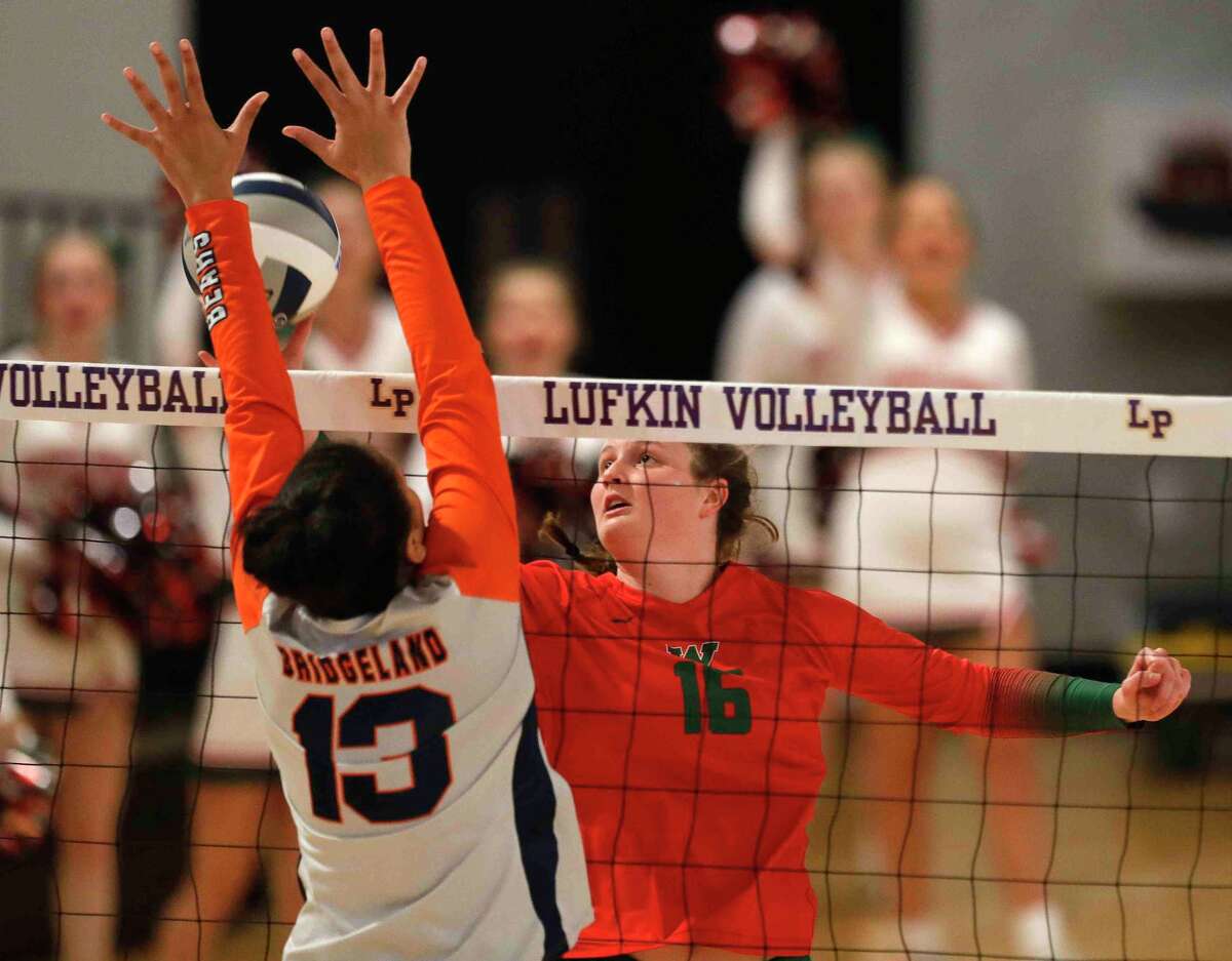 The Woodlands middle blocker Marjorie Johnson (16) has her shot blocked by Bridgeland outside hitter Kennedy Kays (13) during the second set of the Region II-6A final, Saturday, Nov. 13, 2021, in Lufkin.