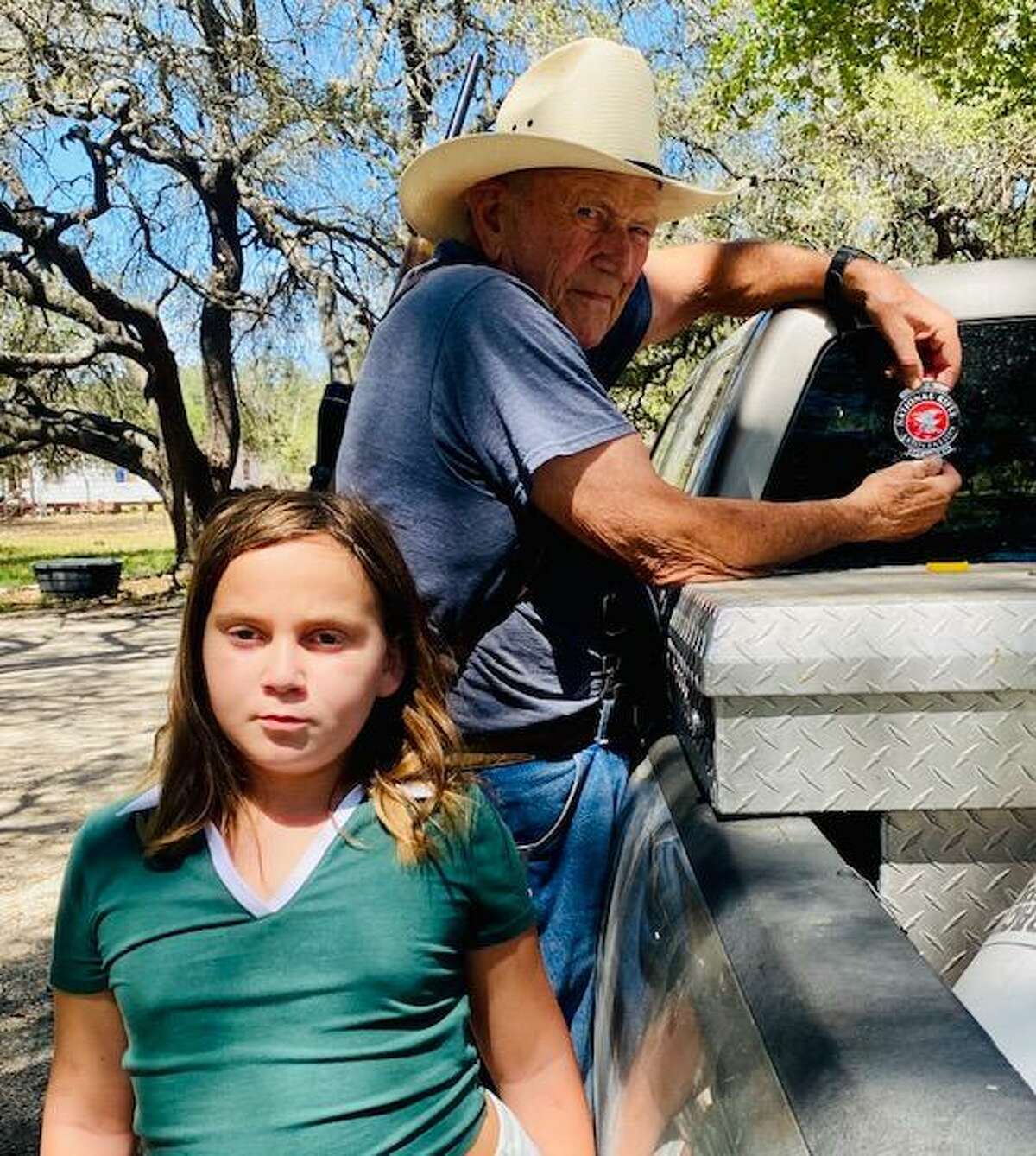 Bernie Phillip, peeling off his NRA sticker, with his 10-year-old granddaughter, Sophie Gronnevik.