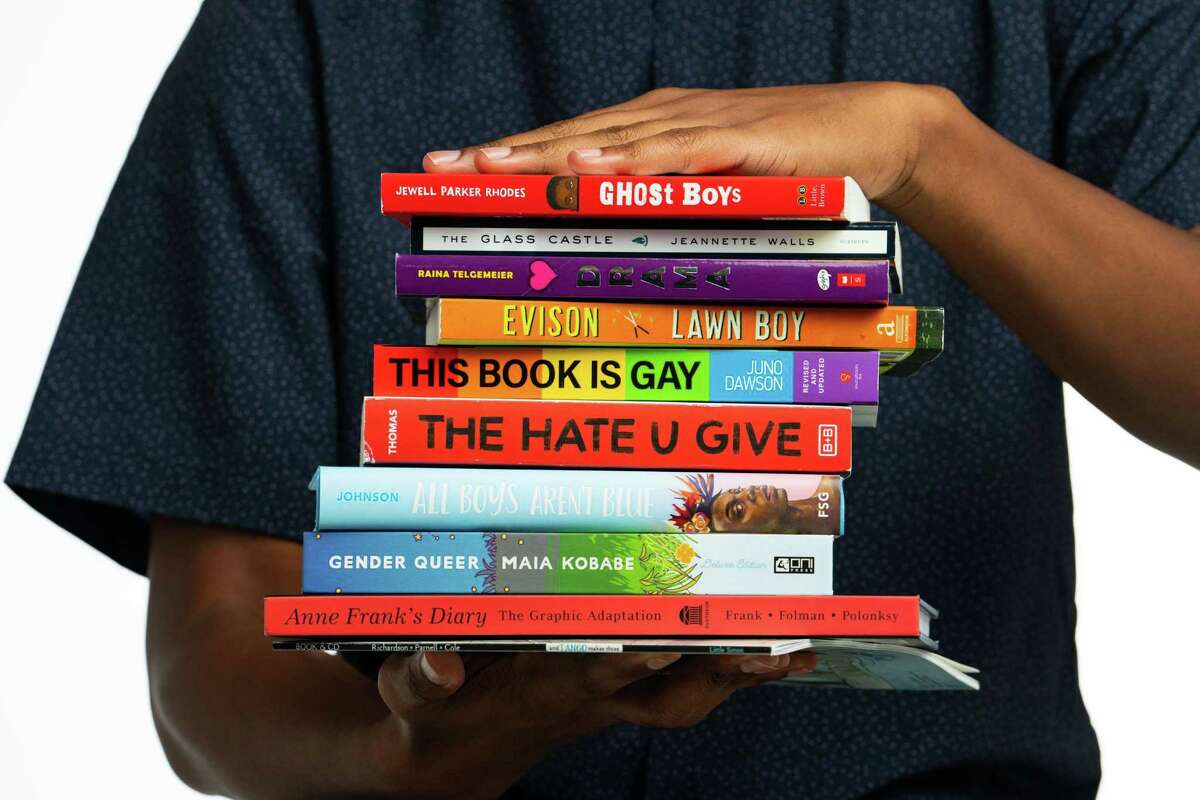 Books that are frequently listed on banned book lists photographed in the Houston Chronicle photo studio, Tuesday, July 19, 2022, in Houston. Books include Ghost Boys, All Boys Aren't Blue, Gender Queer, the Hate U Give, Lawn Boy, This Book is Gay, Anne Frank graphic novel, And Tango Makes Three, The Glass Castle and Drama.