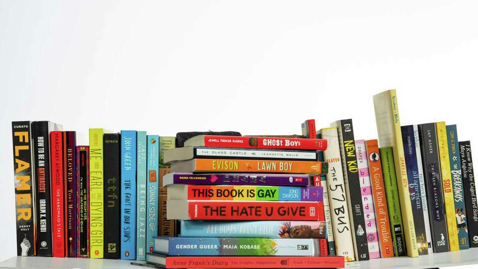 Books that are frequently listed on banned book lists photographed in the Houston Chronicle photo studio, Tuesday, July 19, 2022, in Houston. Books include Ghost Boys, All Boys Aren't Blue, Gender Queer, the Hate U Give, Lawn Boy, This Book is Gay, Anne Frank graphic novel, And Tango Makes Three, The Glass Castle and Drama.