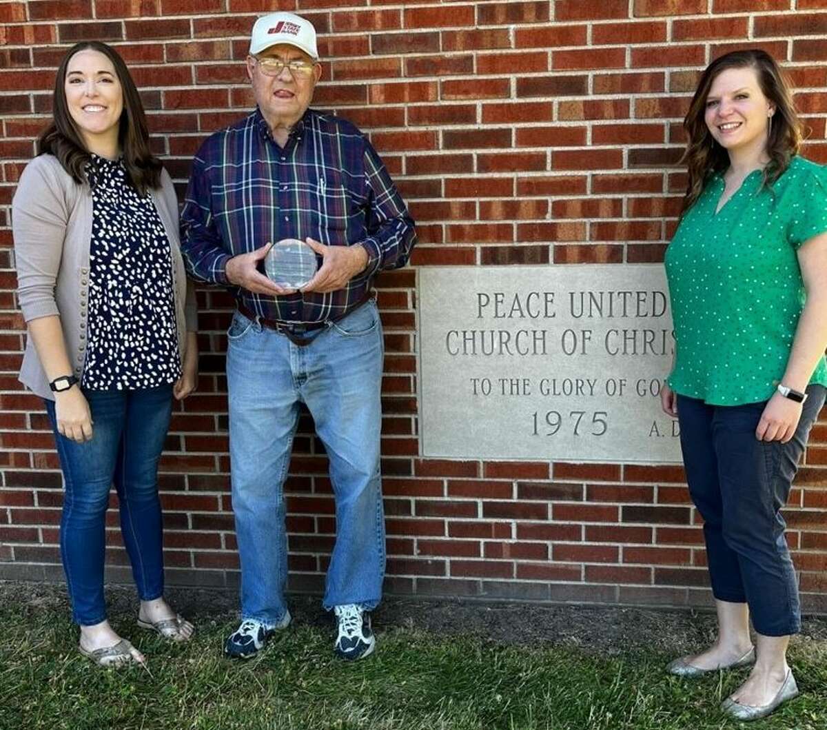 Jessica Jaffry, left, Jersey County 4-H youth development program coordinator, and Lisa Peterson, right, acting county director, present Jim Siebert, a Peace United Church of Christ member, with the 2022 Community Partner Award.