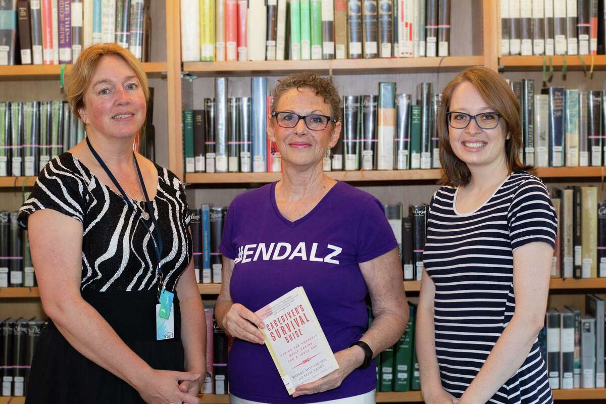 Robin Roscillo, center, poses with Mary-Beth Mason, the knowledge and learning services librarian and Brittany Netherton, Darien Library’s head of knowledge and learning services.