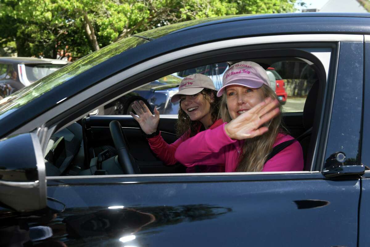 Live Green Executive Director and Co-founder Daphne Dixon, right, and EV Program Manager Alyssa Murphy depart from the Sherman Green, in Fairfield, Conn. June 6, 2022. Dixon and Murphy are driving an electronically charged Ford Mustang on a three-week trip that will take them to California.
