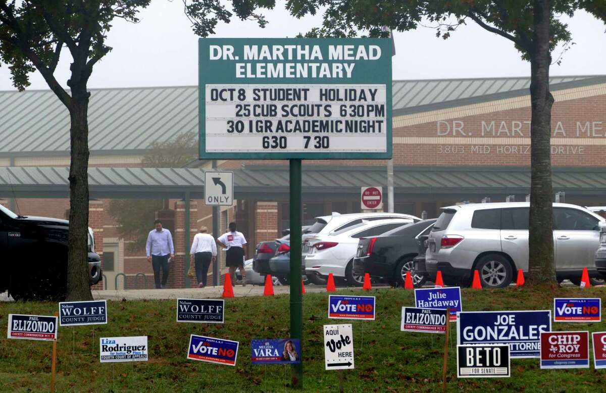 Voters and arrive and leave Dr. Martha Mead Elementary School, a polling place near Medical Center, on Tuesday, Nov. 6, 2018.