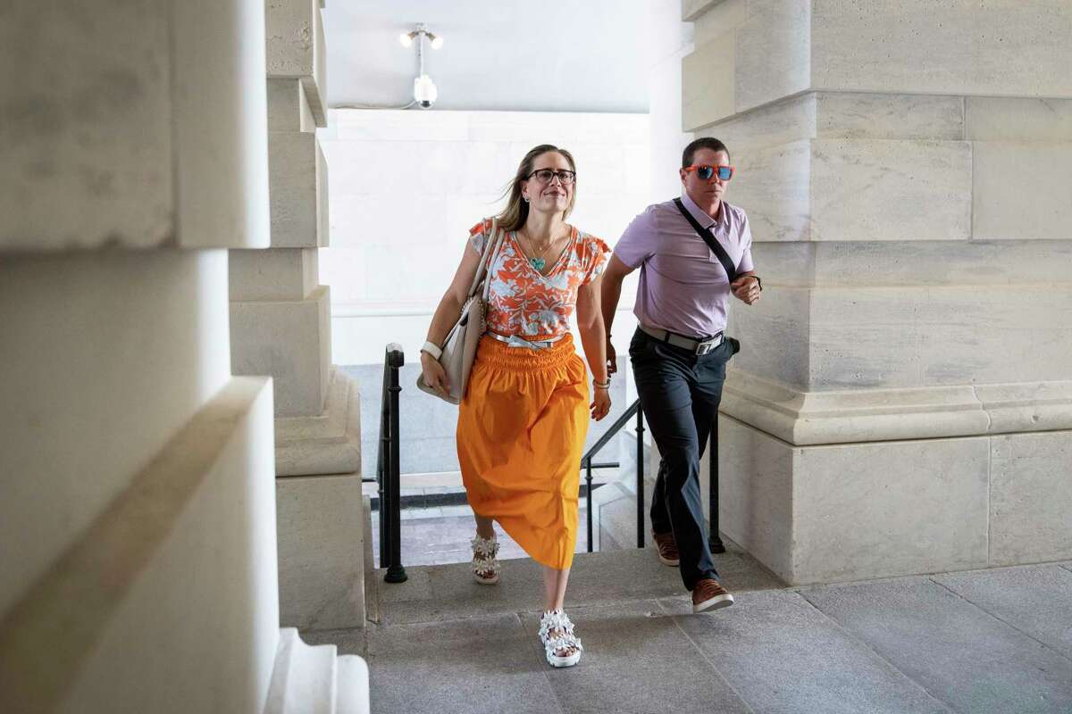 U.S. Sen. Kyrsten Sinema, D-Ariz., arrives at the U.S. Capitol for a vote on Aug. 4, while she was negotiation to preserve the carried interest tax loophole for hedge fund managers. The U.S. Senate passed the Inflation Reduction Act of 2022 three days later.