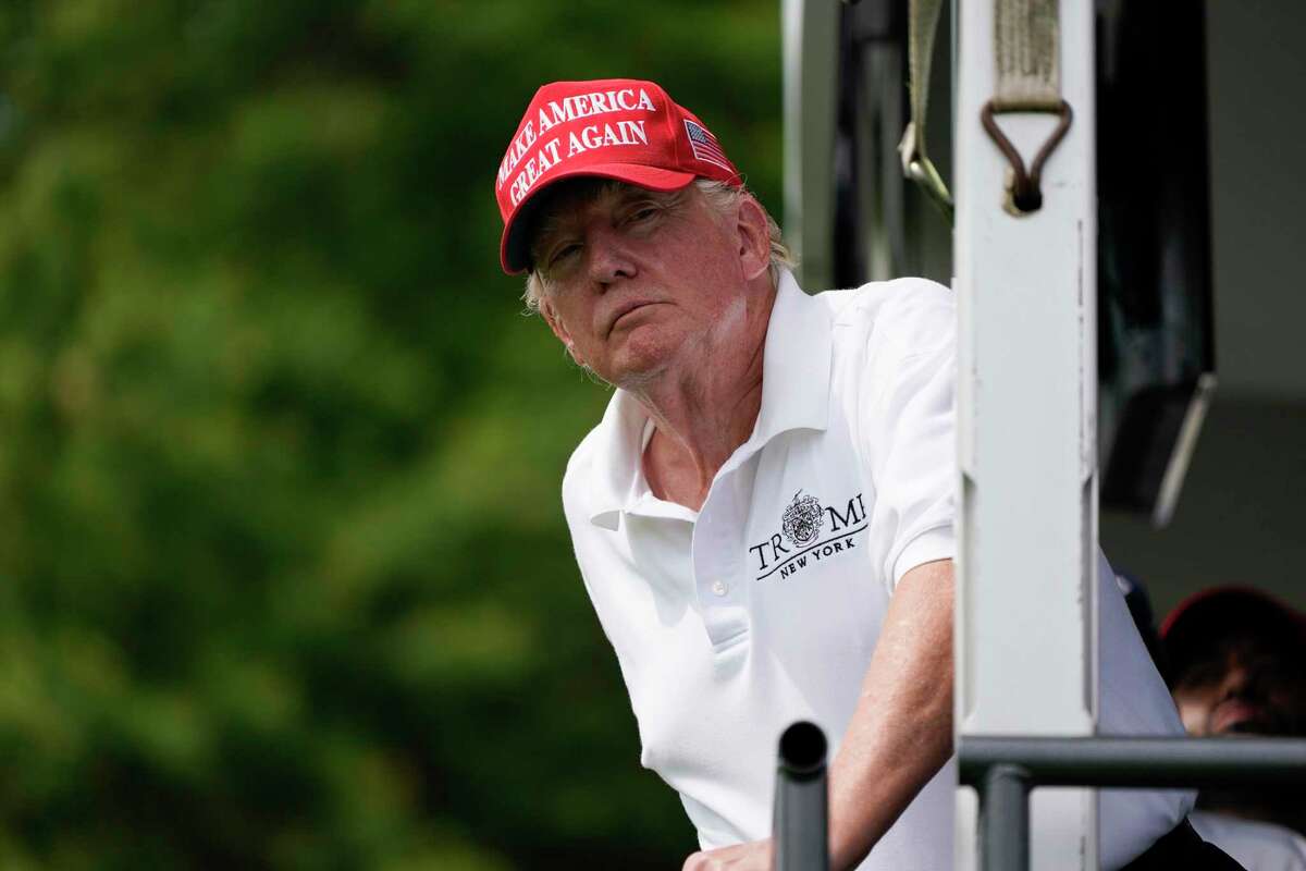 Former President Donald Trump interacts with the crowd during the final round of the Bedminster Invitational LIV Golf tournament in Bedminster, N.J., Sunday, July 31, 2022. (AP Photo/Seth Wenig)