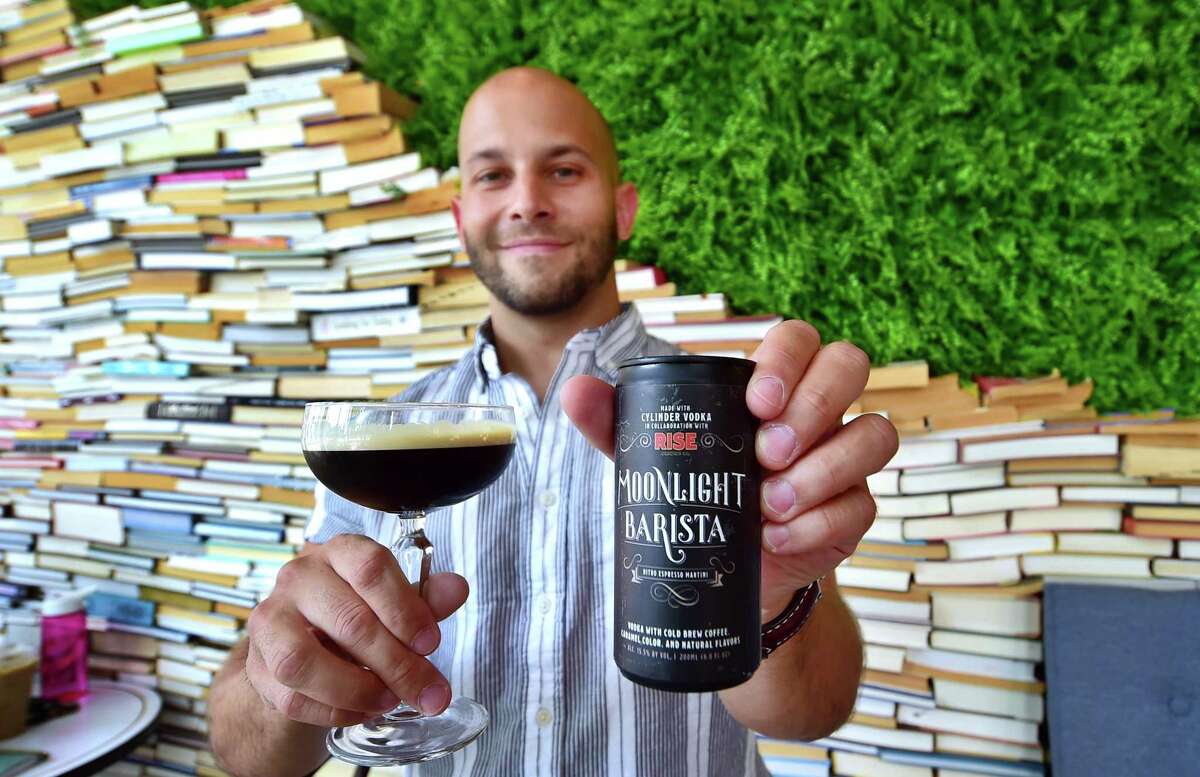 CoreBev Group founder and Chief Executive Officer Stelios Stavrianos poses with Moonlight Barista, the new nitro espresso martini produced by his company and Rise Brewing Co., at Winfield Street Coffee at 96 Broad St., in Stamford, Conn., on Tuesday, July 26, 2022. s