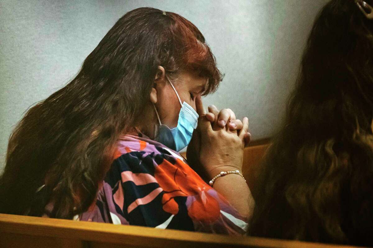 Patricia Owens, the mother of 18-year-old Amina Said and 17-year-old Sarah Said, bows her head and closes her eyes before the jury charge is read during trial for Yaser Said, Tuesday, Aug. 9, 2022, at the Frank Crowley Criminal Courts Building in Dallas. Yaser Said faces a charge of capital murder and an automatic life sentence if convicted of killing his daughters on New Year's Day 2008, after evading capture for 12 years. (Juan Figueroa/The Dallas Morning News via AP)