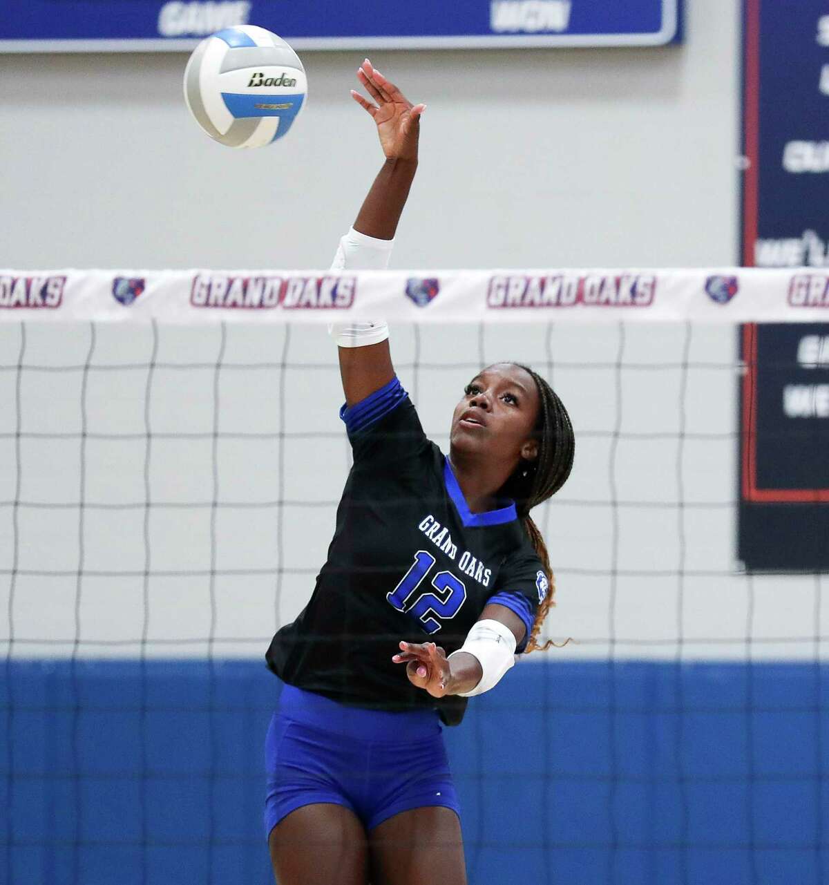 Grand Oaks' Samara Coleman (12) hits a shot in the first set of a non-district high school volleyball match at Grand Oak High School, Tuesday, Aug. 9, 2022, in Spring.