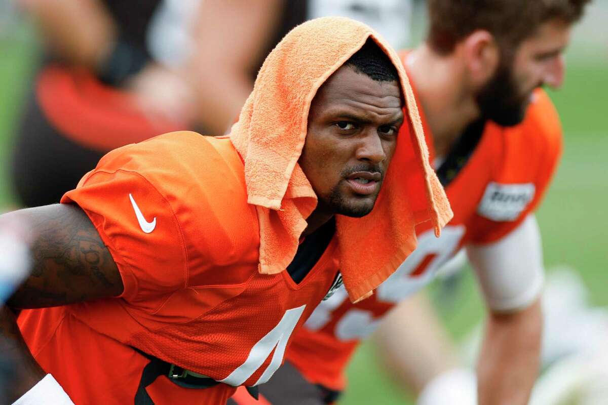 Cleveland Browns quarterback Deshaun Watson stretches during the NFL football team's training camp, Tuesday, Aug. 9, 2022, in Berea, Ohio. (AP Photo/Ron Schwane)