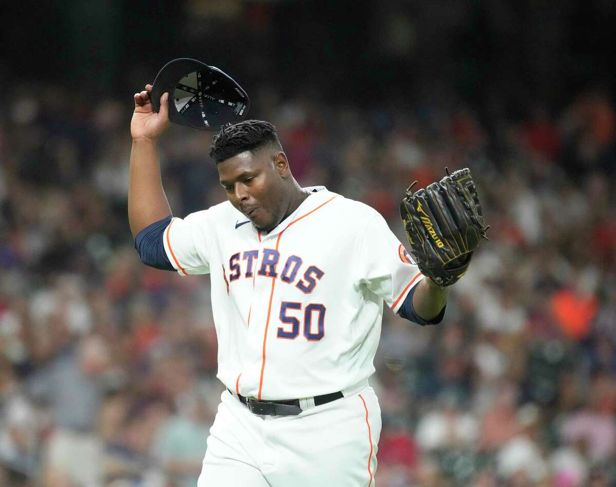 Houston Astros relief pitcher Hector Neris (50) reacts after striking out Texas Rangers Josh Smith (47) during the eighth inning of an MLB baseball game at Minute Maid Park on Tuesday, Aug. 9, 2022 in Houston.