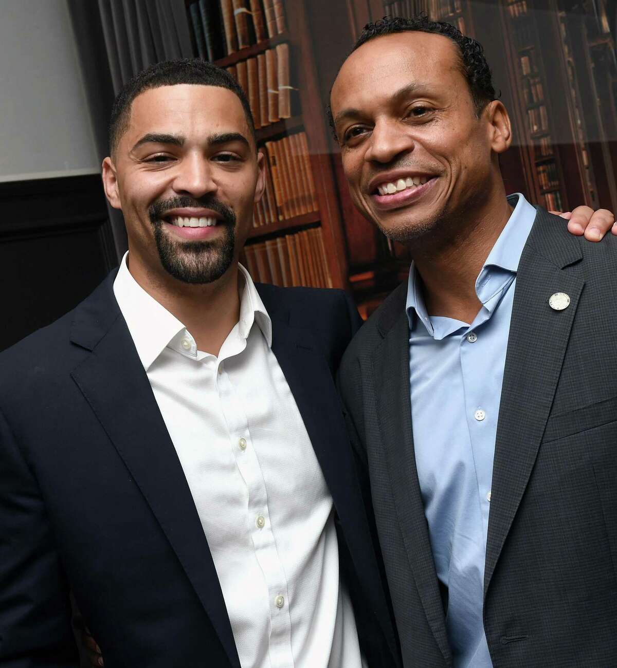 Democratic treasurer candidate Erick Russell, left, celebrates with outgoing treasurer Shawn Wooden at the Trinity Bar in New Haven on August 9, 2022.