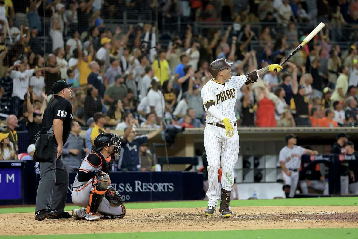 SAN DIEGO, CALIFORNIA - AUGUST 09: Manny Machado #13 of the San Diego Padres reacts after hitting a three-run homerun as Austin Wynns #14 of the San Francisco Giants looks on during the ninth inning of a game at PETCO Park on August 09, 2022 in San Diego, California. (Photo by Sean M. Haffey/Getty Images)