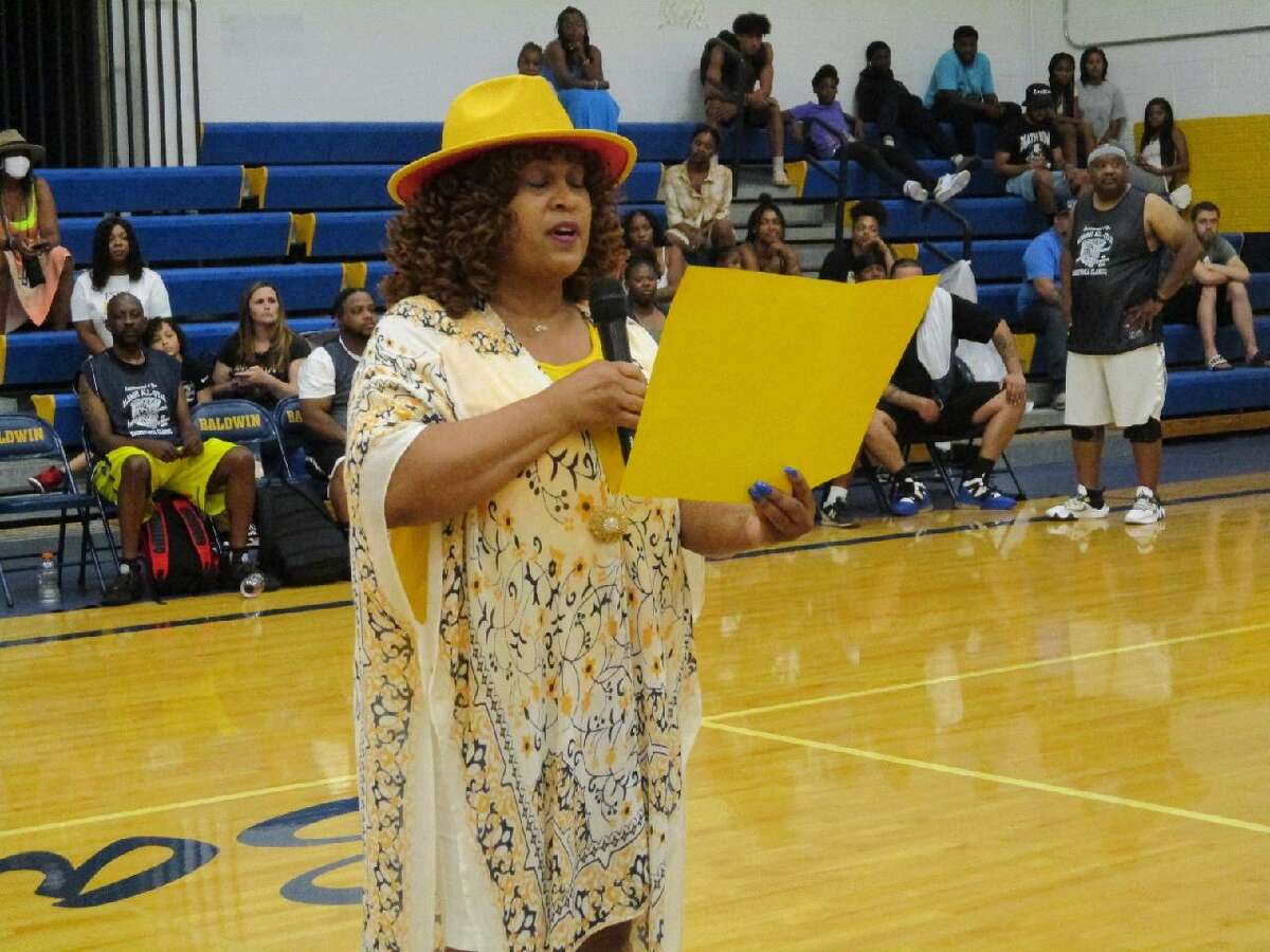 Erica Grier Anderson pays tribute to former Baldwin administrator Al Nichols on behalf of Baldwin alumni at a special presentation recently in the high school gymnasium.