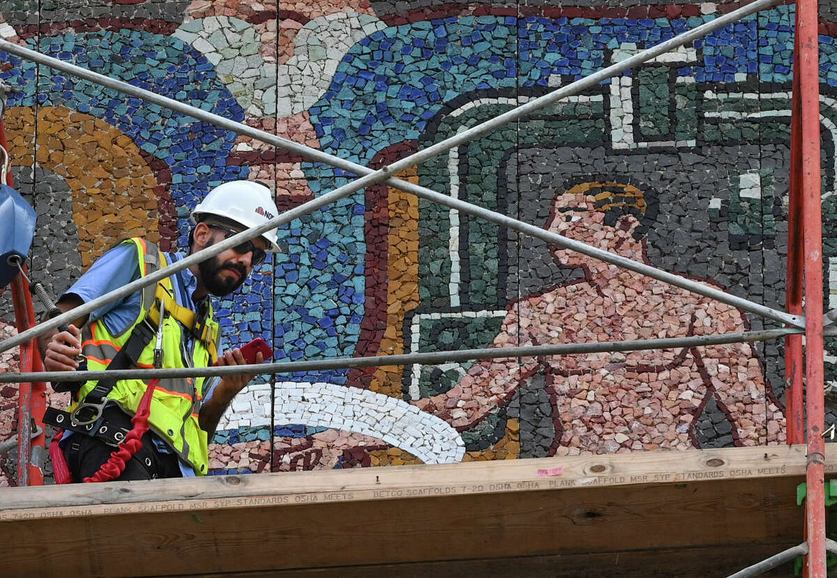 A small crew is working to clean and restore the mural by Mexican artist and architect Juan O’Gorman on the Lila Cockrell Theatre at the Henry B. Gonzalez Convention Center. The mural was installed in 1967 just ahead of HemisFair ’68, for which it had been commissioned.