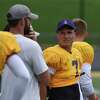 University at Albany quarterback Reese Poffenbarger works with coaches on the sideline during practice on Wednesday, Aug. 10, 2022, at Casey Stadium in Albany, N.Y.