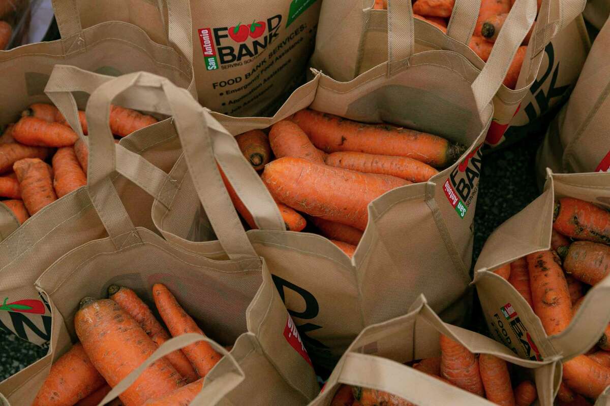Bags of carrots are ready to be loaded into vehicles during the San Antonio Food Bank’s giveaway at Gustafson Stadium in November 2021. The Food Bank has been awarded a $300,000 grant from UnitedHealthcare.