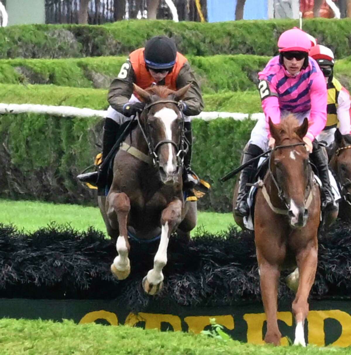 State of Affair, left, with jockey Thomas Garner, battles for the lead with Hurtgen Forest and Jamie Bargary in the 2 1/16-mile steeplechase allowance race at Saratoga Race Course on Wednesday Aug. 10, 2022.