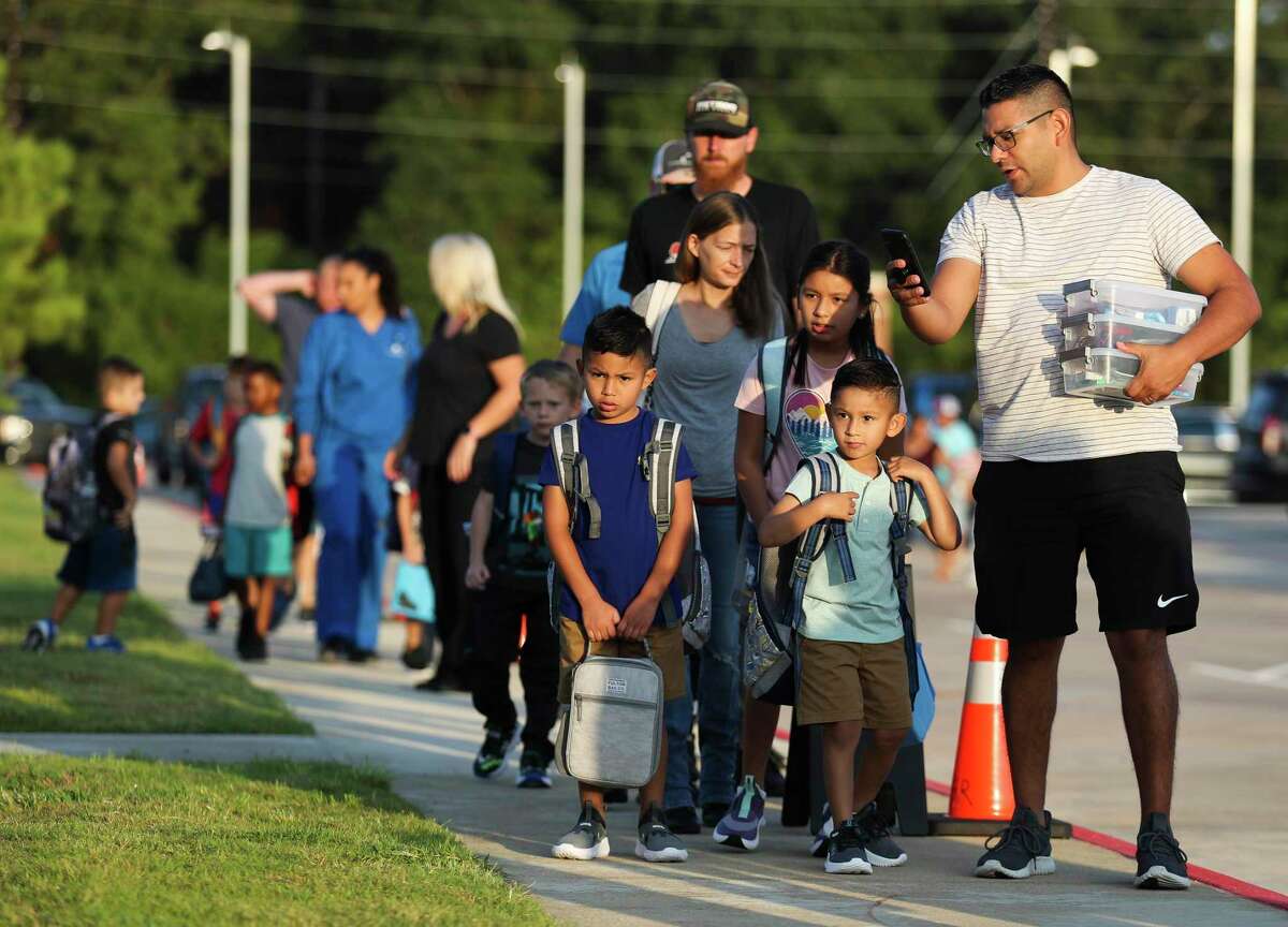 Gabriel Garza directs his kids for a photo on the first day of school at Annete Gordon Reed Elementary, Wednesday, Aug. 10, 2022, in Montgomery.