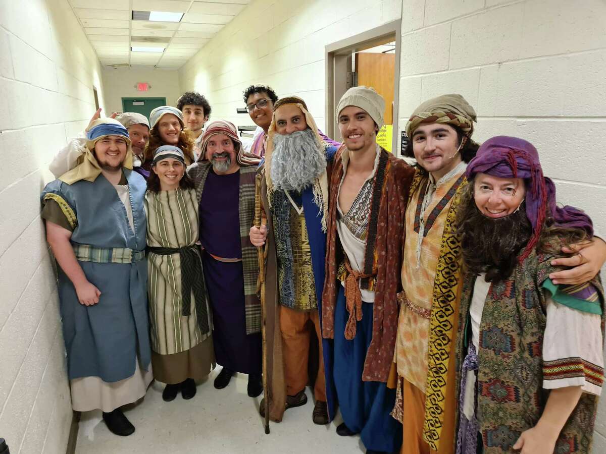 Ensemble of “Joseph and the Amazing Technicolor Dreamcoat” poses for photos before a dress rehearsal begins at Hamden High School’s auditorium in Hamden on Aug. 8, 2022.